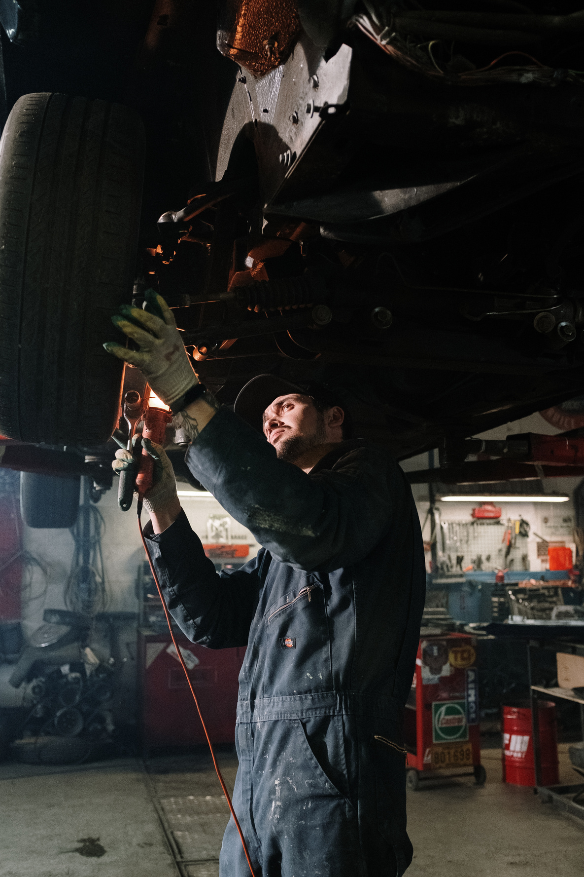 Man in Black Jacket Holding Black and Red Power Tool